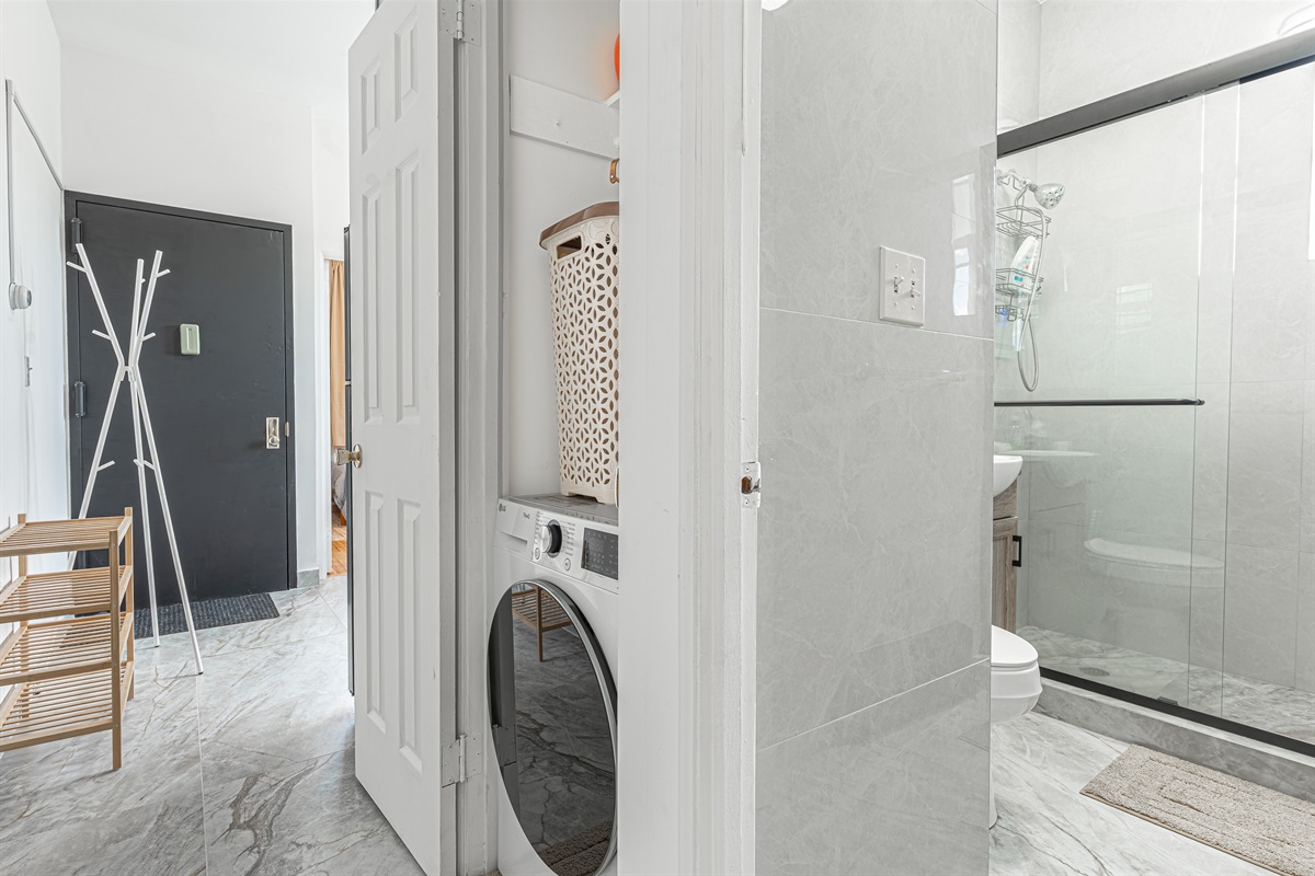 Sleek hallway connecting the bath and laundry — clean lines and easy flow between rooms.