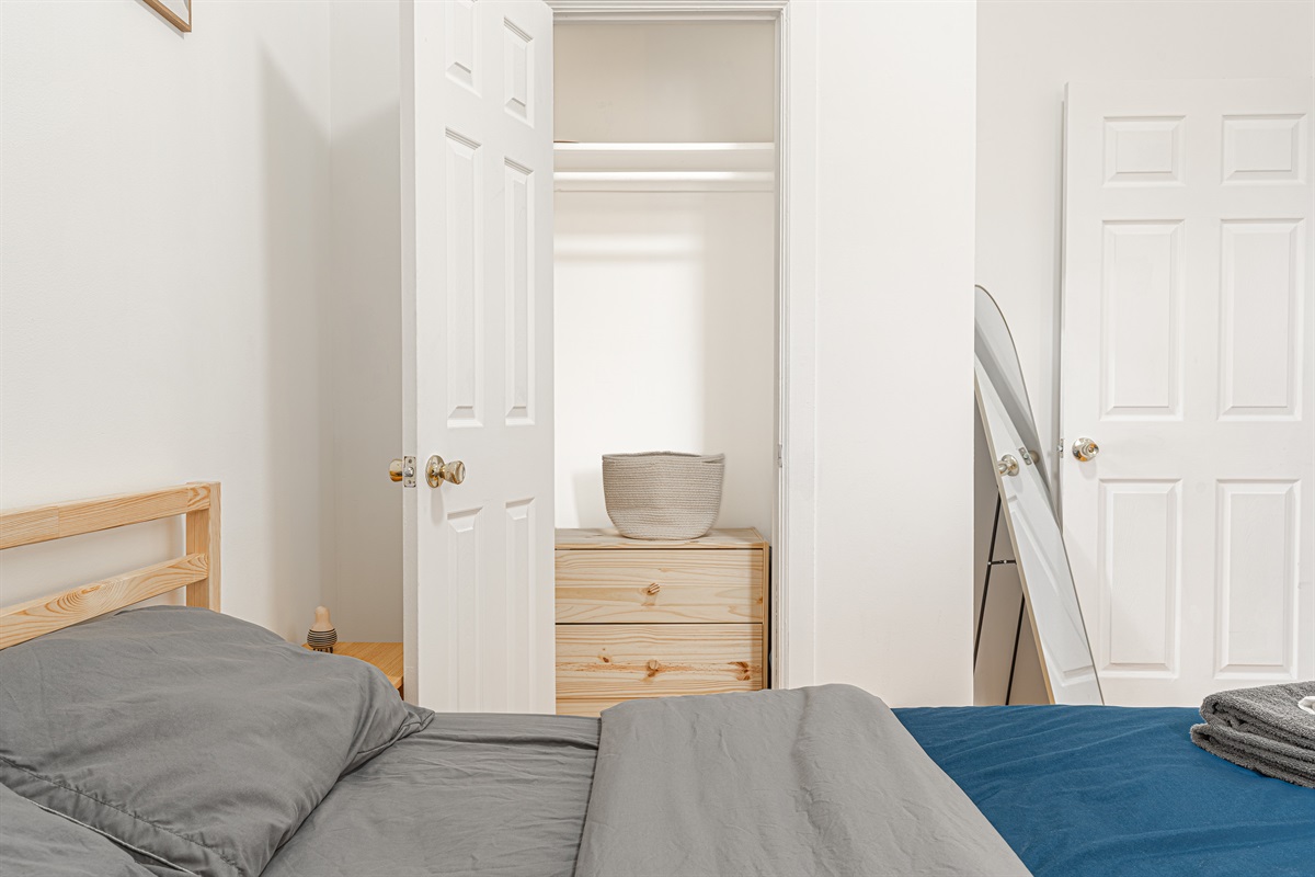 Restful bedroom with a comfortable bed, fresh linens, and a closet plus dresser for easy unpacking.