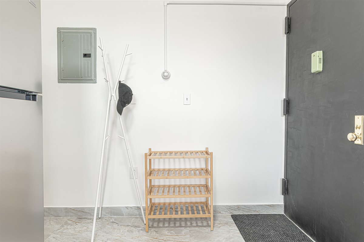 Welcoming entry with shoe rack and coat stand — drop your bags and settle in the moment you arrive.