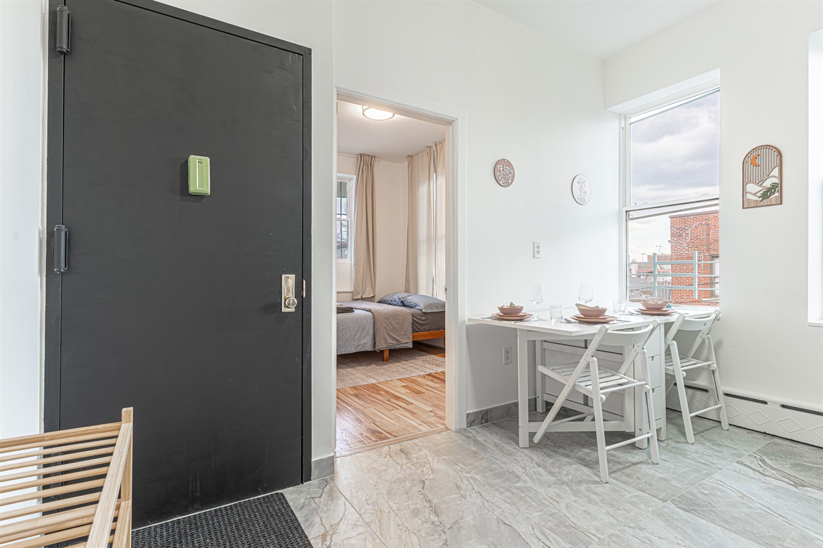 Bright, open layout flowing from entry to dining and bedroom — comfortable, easy living in the heart of Queens.