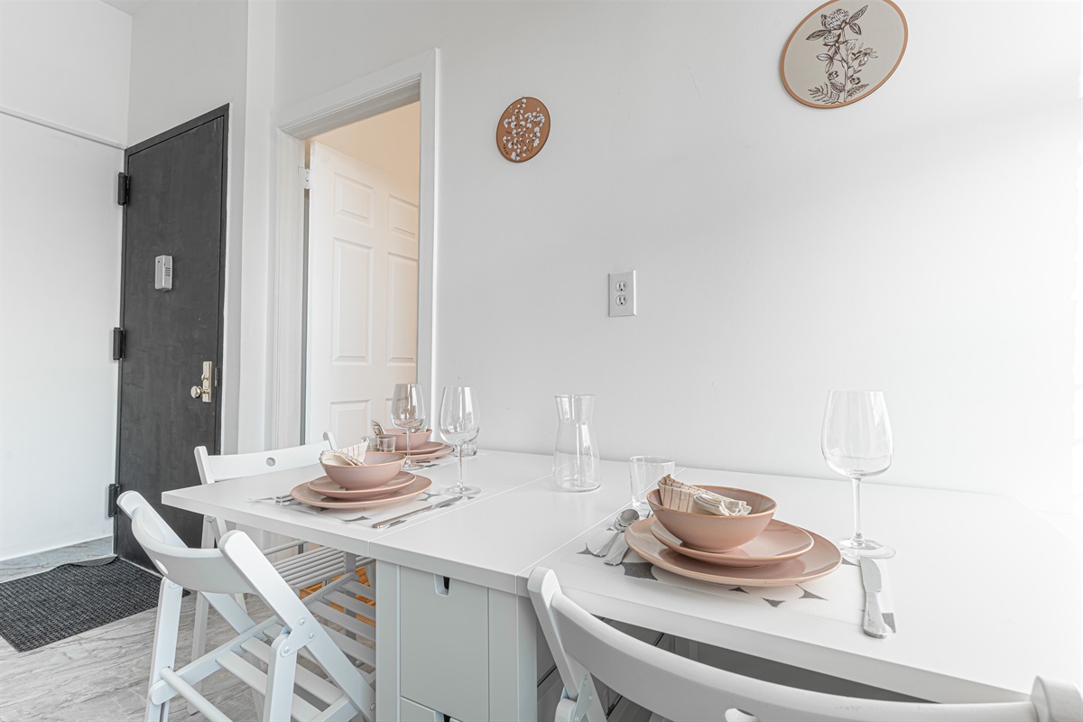 Bright dining area with seating for the whole group — gather for breakfast before hopping the 7 train into Manhattan.