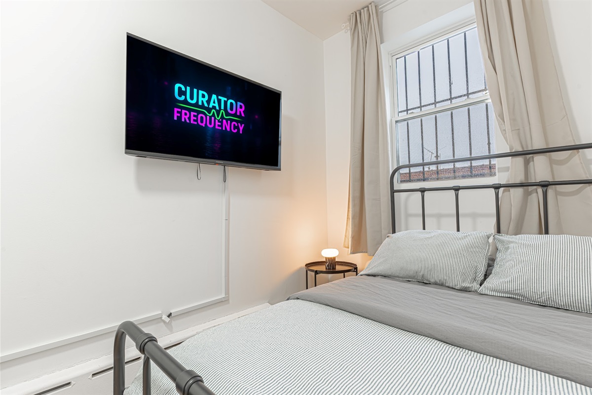 Relax in the bedroom with a smart TV and easy comfort — wind down after exploring NYC.