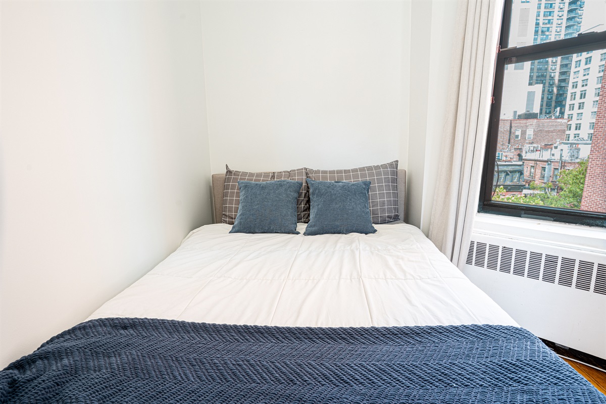 Cozy bedroom with city views and a comfy full-size bed