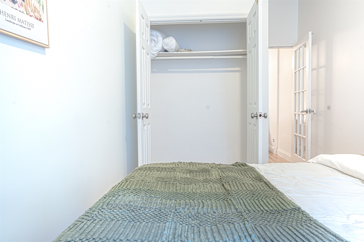 Restful primary bedroom with double closets and cozy bedding — plenty of space to store your things and stretch out.