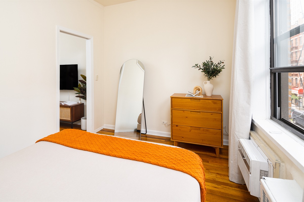 Minimalist bedroom with warm light and modern charm.