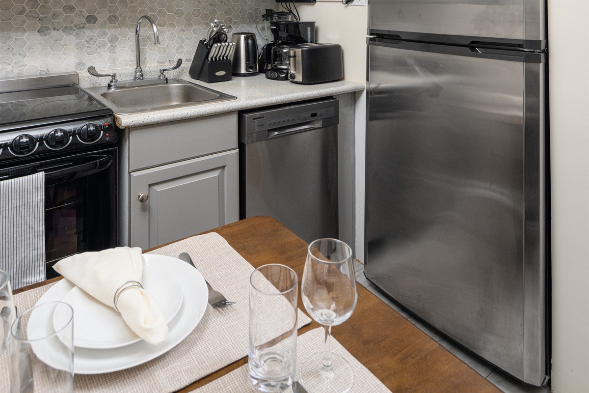 Modern kitchen with full amenities and cozy dining.