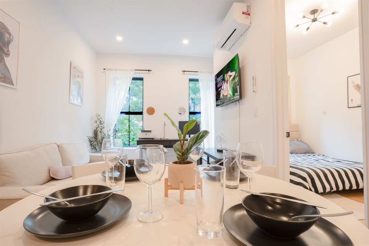 Elegant dining setup with cozy lounge, desk, and natural light