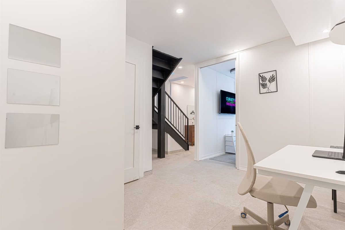 Dining-and-work nook with a desk beside the staircase to the duplex's second level — room to spread out across two floor