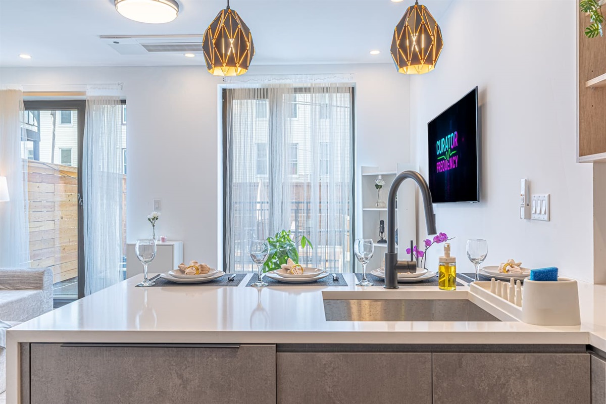 Fully renovated kitchen with a big island, modern fixtures, and bright windows — cook, gather, and dine all in one airy