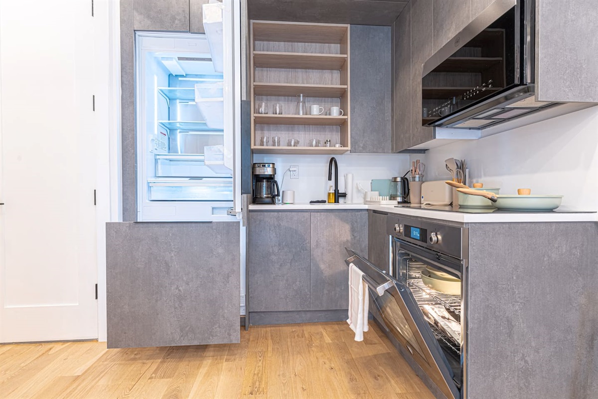 Open shelving and clean counters keep this stylish kitchen organized and effortless to cook in.