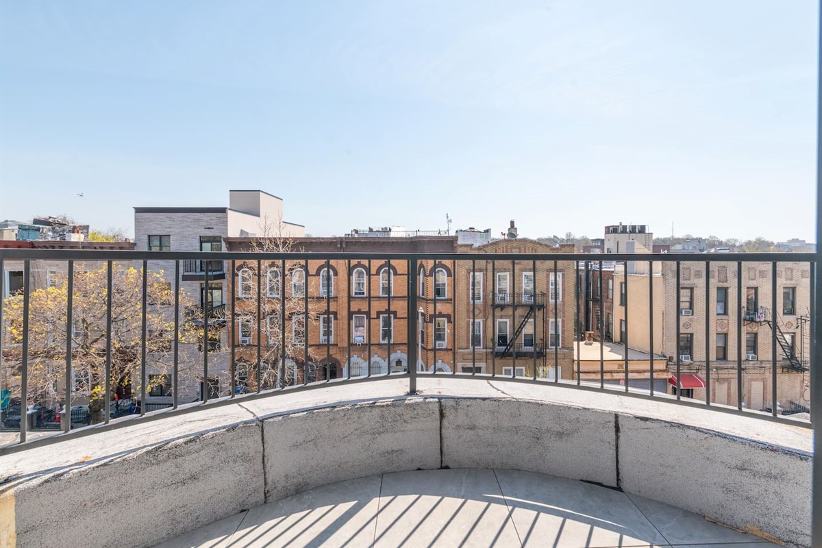 Step out to your private balcony and take in sweeping Brooklyn rooftop views under open sky.
