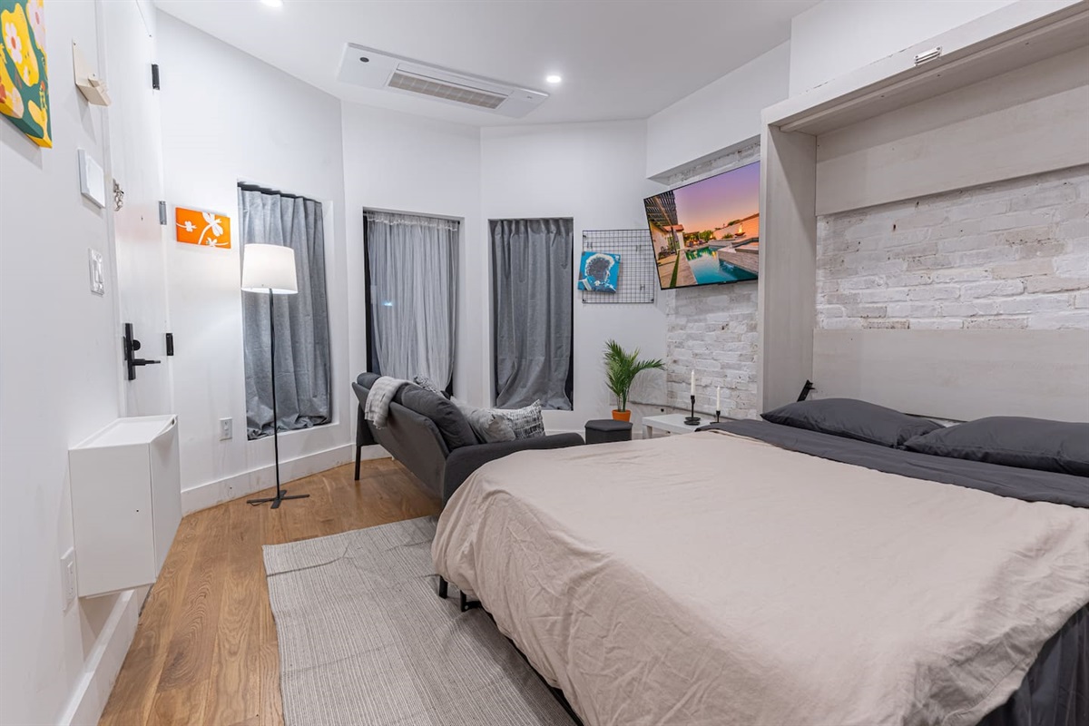 Bright, renovated studio with a comfortable bed and exposed-brick accent wall — your stylish, easy Brooklyn base just st