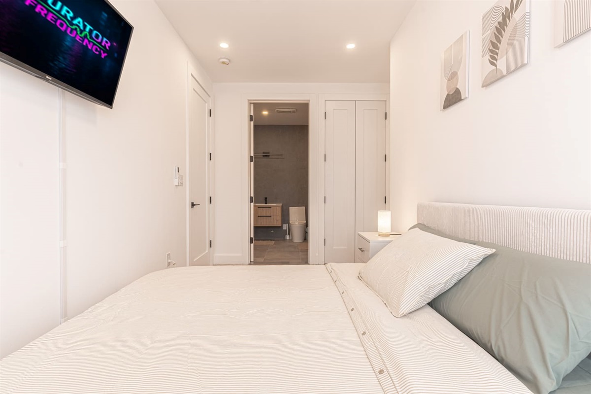 Bright entry and hallway leading into the spacious, light-filled apartment.