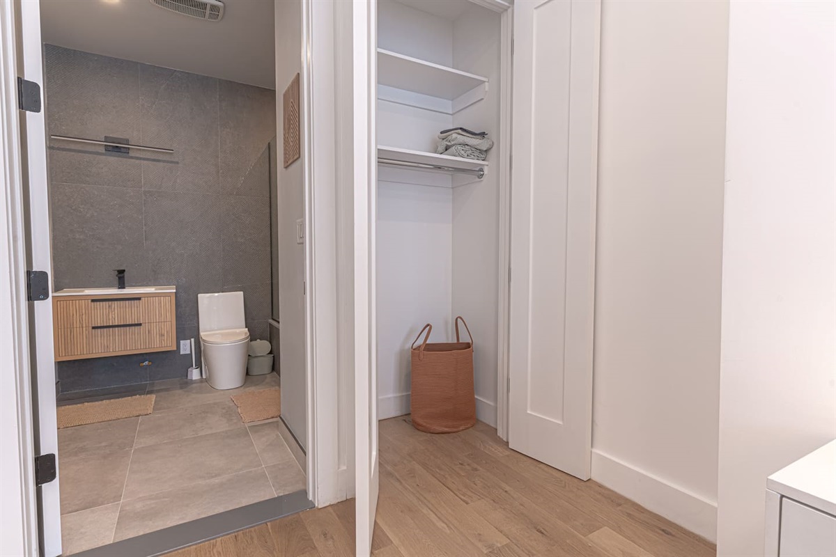 Calm bedroom with crisp, fresh linens and a private bath just steps away — easy, comfortable rest.