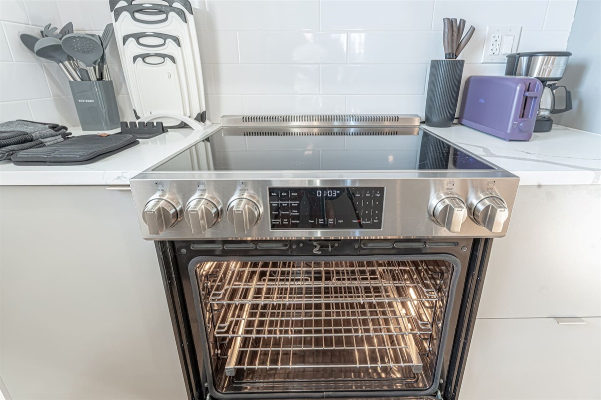 Electric oven and smooth cooktop in modern Scandinavian kitchen, perfect for home-cooked meals