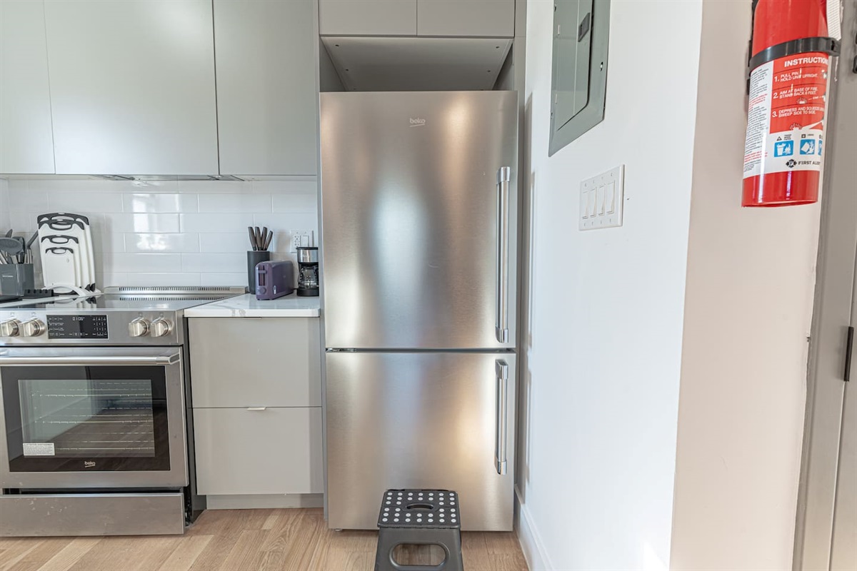 Stainless‑steel appliances, cookware and boho accents make cooking a pleasure.
