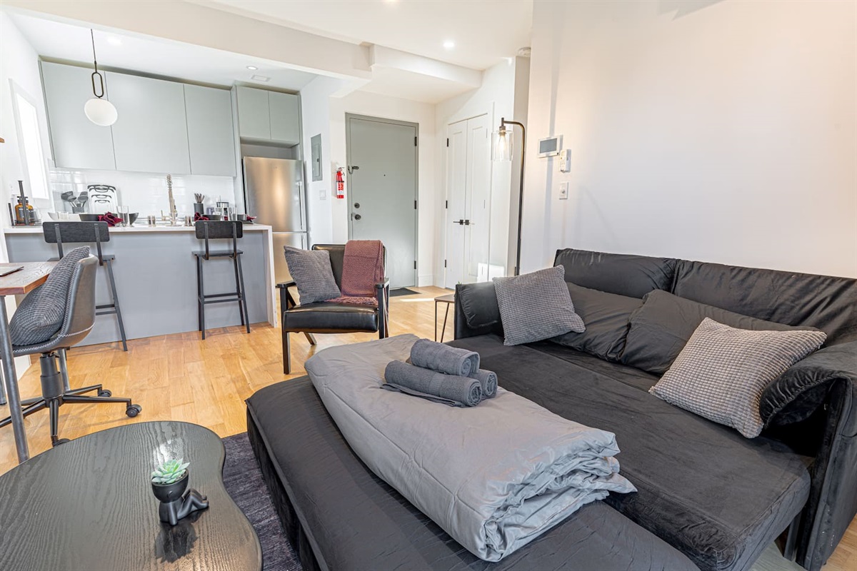 Comfortable sofa in bright living room, ideal for relaxing after exploring Brooklyn and Manhattan
