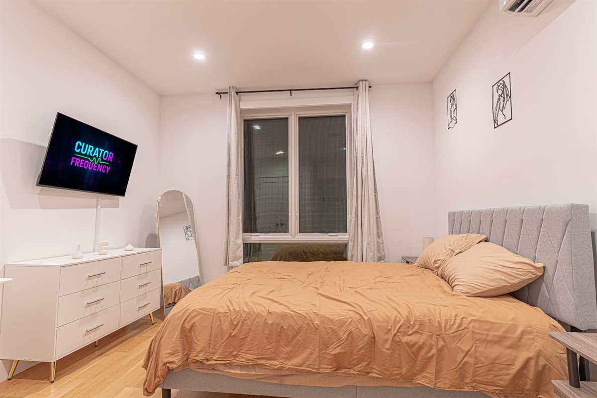Modern bedroom with queen‑size bed, boho décor and soft lighting ensures restful nights.