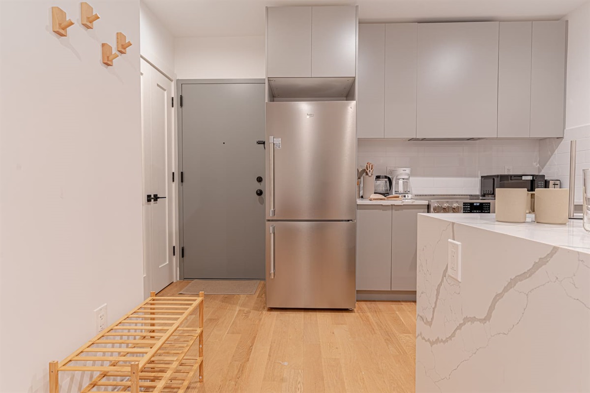 Full-size refrigerator and freezer combo keep groceries fresh during extended stays in Brooklyn.
