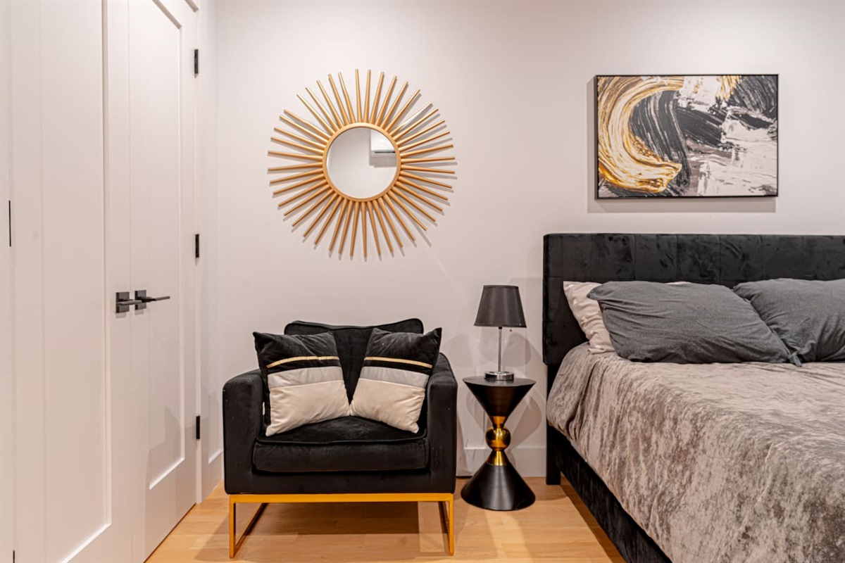 Stylish bedroom setup with chic décor, wall art and soft bedding blending comfort and aesthetics
