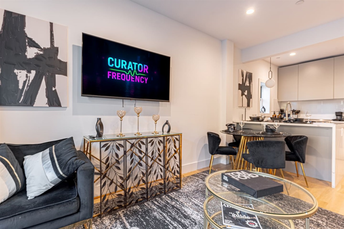 Cozy lounge with wall-mounted smart TV, modern console and stylish décor for entertainment nights