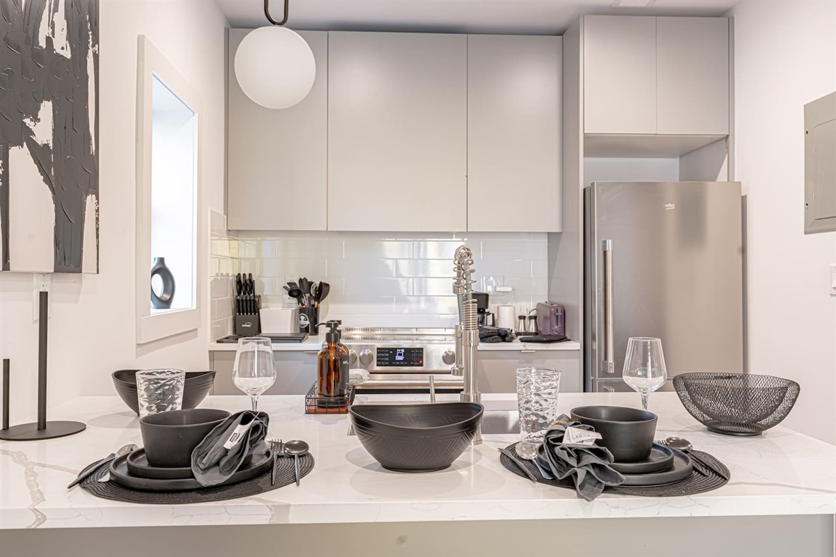 Modern kitchen island with bar stools, offering a casual dining spot and added counter space
