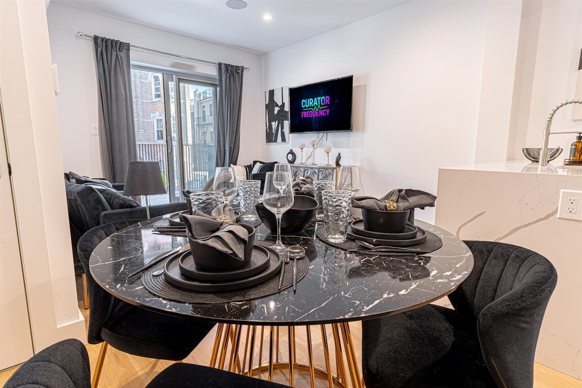 Modern kitchen with stainless appliances, sleek cabinetry, breakfast bar and essentials for cooking