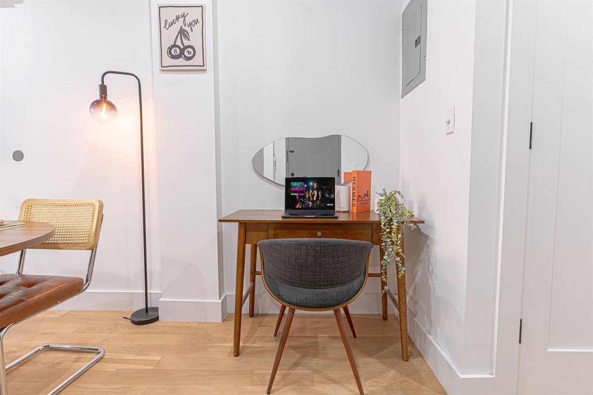 Dedicated work-from-home nook with a stylish desk, comfy chair, and warm lighting—perfect for Zoom calls, emails, or jou