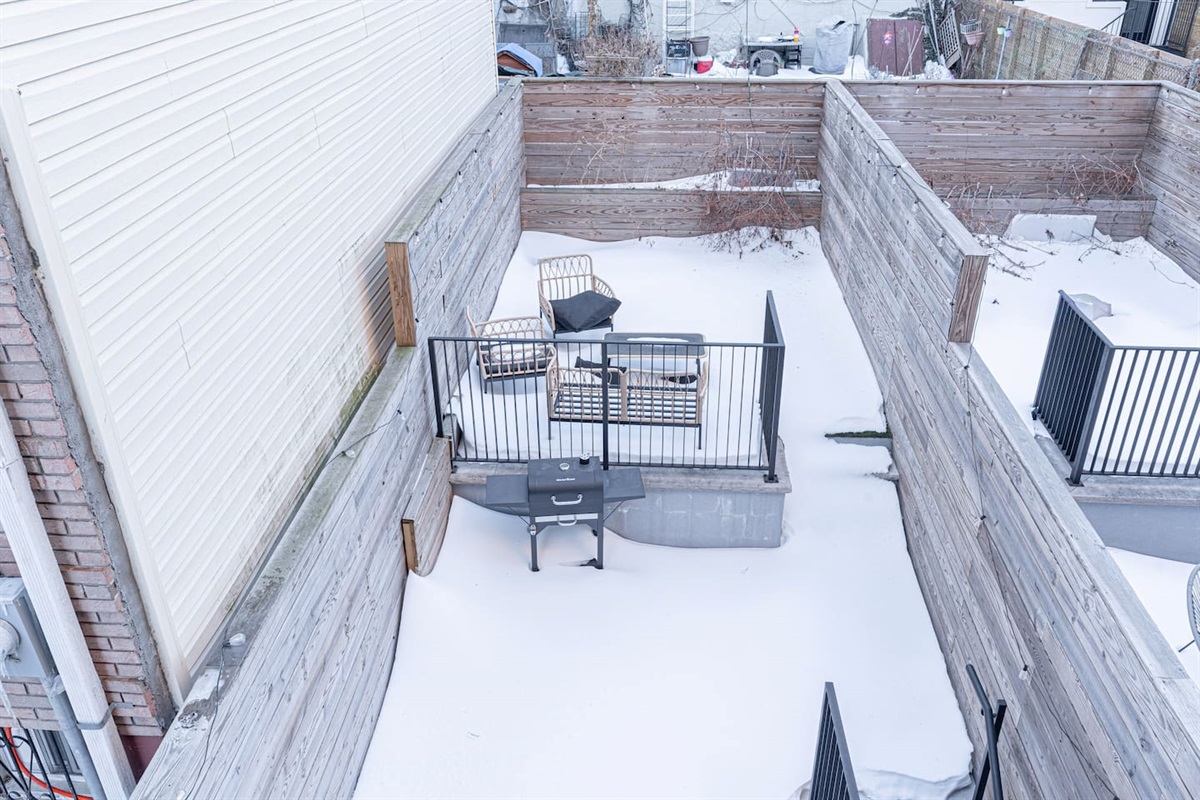 Private fenced outdoor patio—your own city escape with lounge seating and a grill for easy cookouts. Sip coffee, unwind