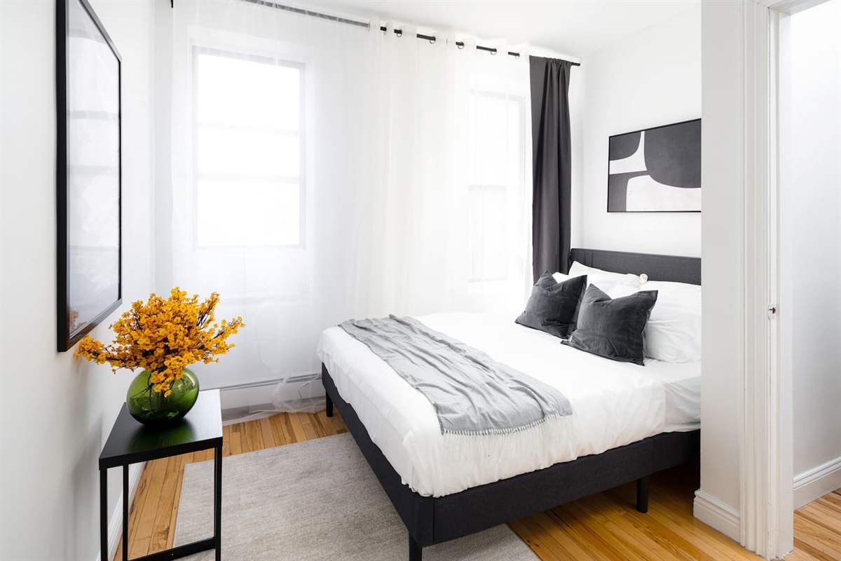Bright bedroom with modern decor and bold floral accent