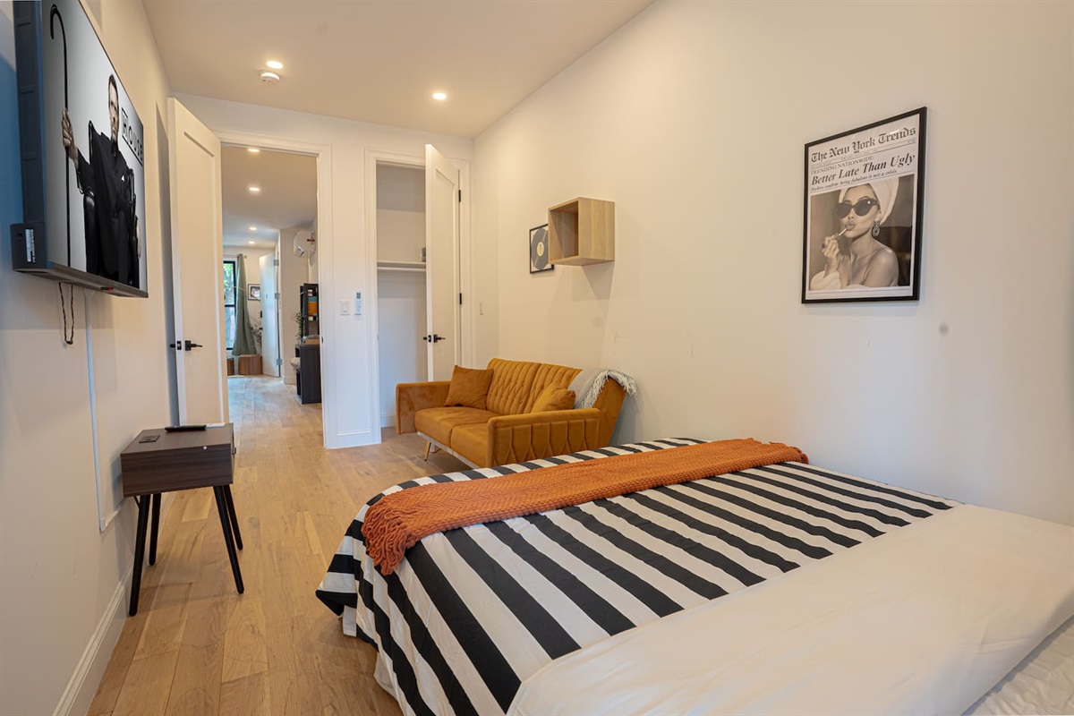 Cozy yet stylish room with a queen bed, TV and warm modern décor for relaxing nights
