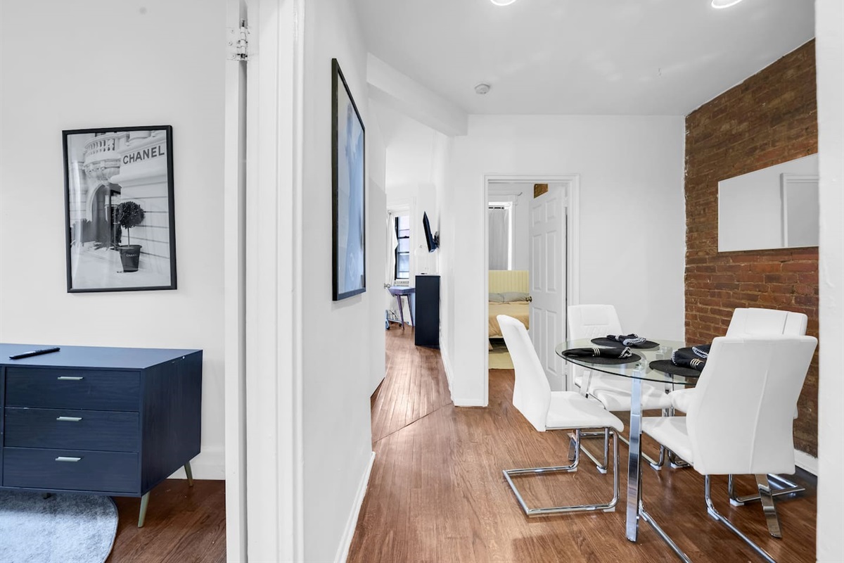 Open hallway flowing into the dining area with brick-accent charm — a warm, contemporary 3BR layout perfect for families