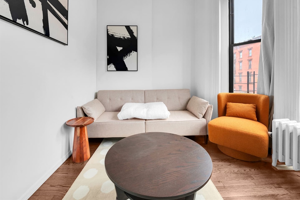 Bright, welcoming living room with plush seating and large windows — your stylish home base in family-friendly Prime Par