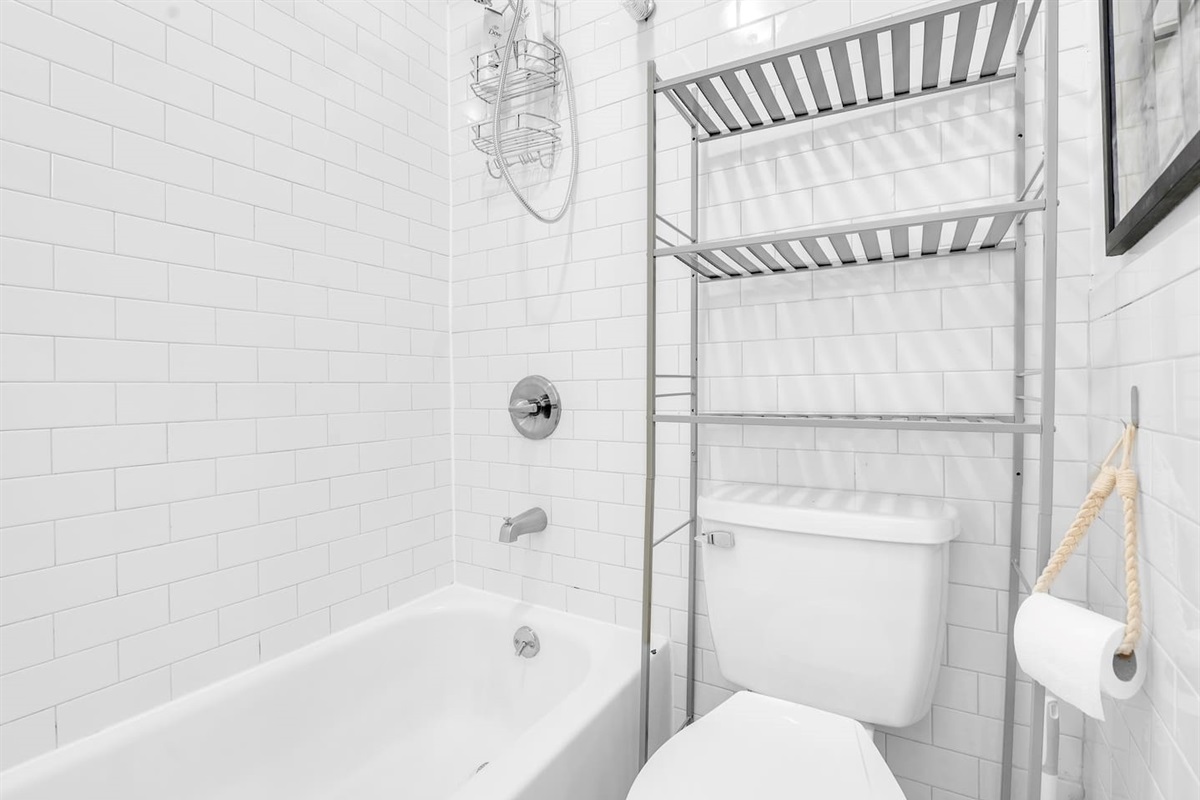 Bright bathroom with tub-shower combo and subway tile — hotel-quality essentials ready when you arrive.