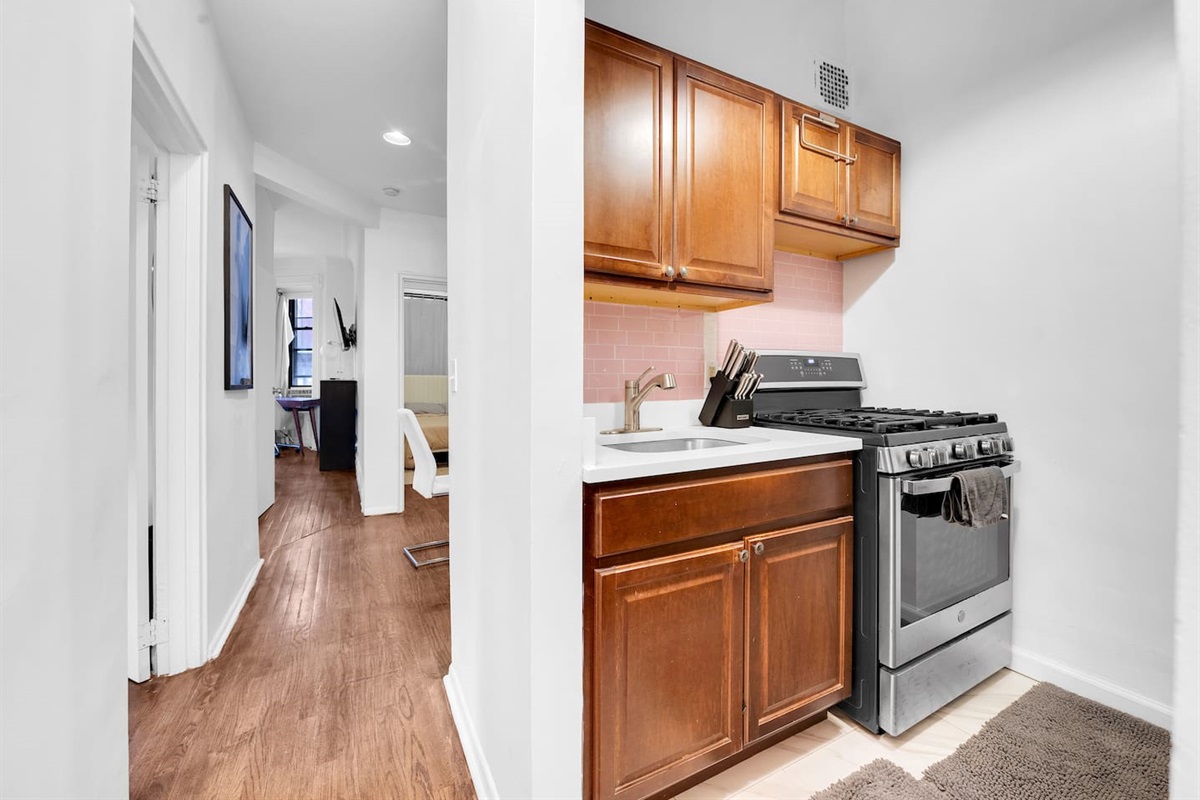 Kitchen with full-size refrigerator, microwave, and generous storage — fully equipped for short or extended stays.