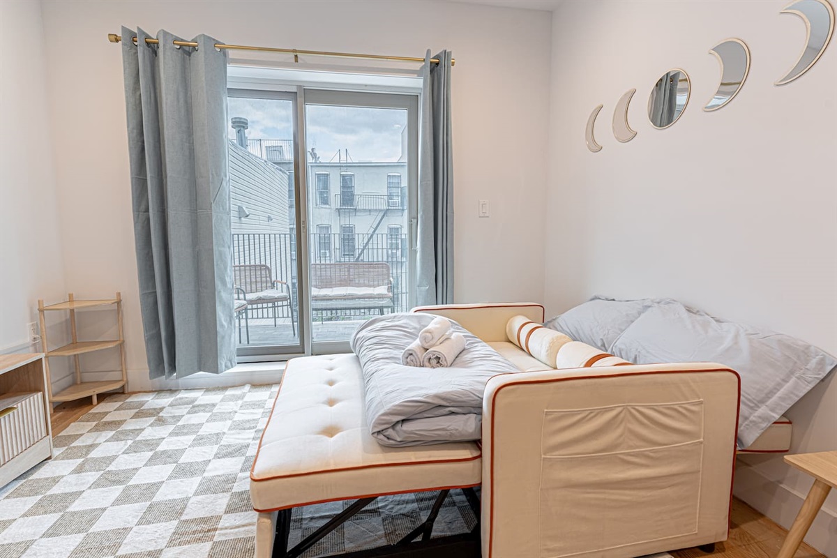 Comfortable sofa in bright living room, ideal for relaxing after exploring Brooklyn and Manhattan