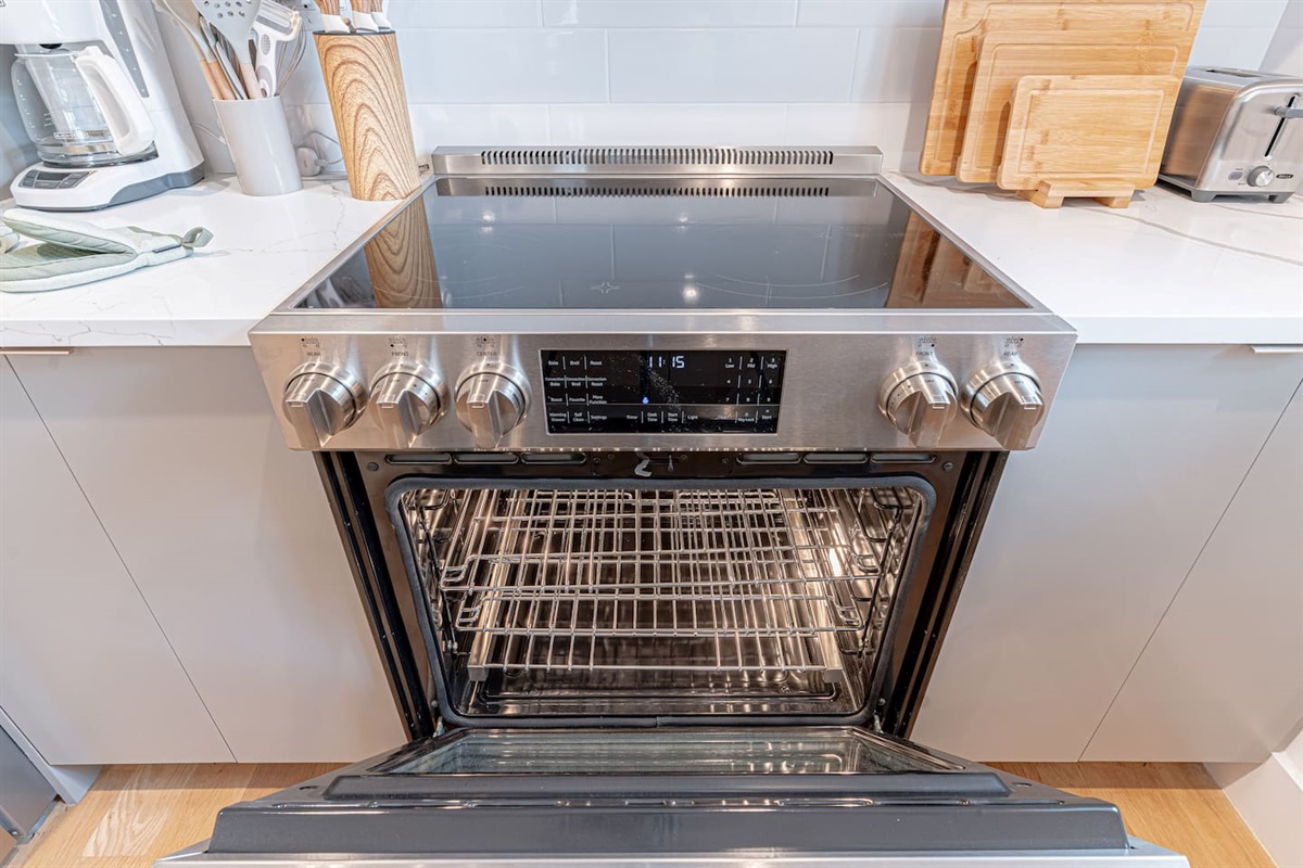 Electric oven and smooth cooktop in modern Scandinavian kitchen, perfect for home-cooked meals