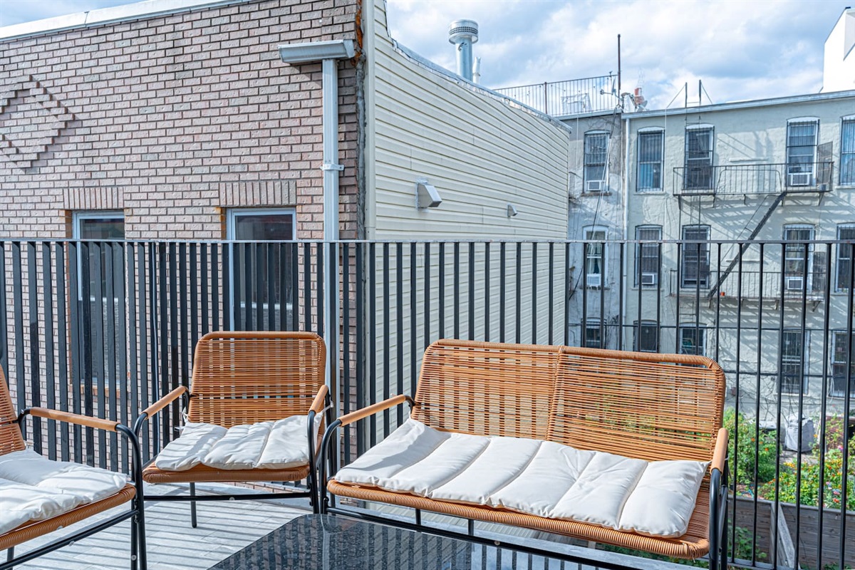 Private balcony seating for morning coffee or sunset wine in quiet Bushwick Scandinavian