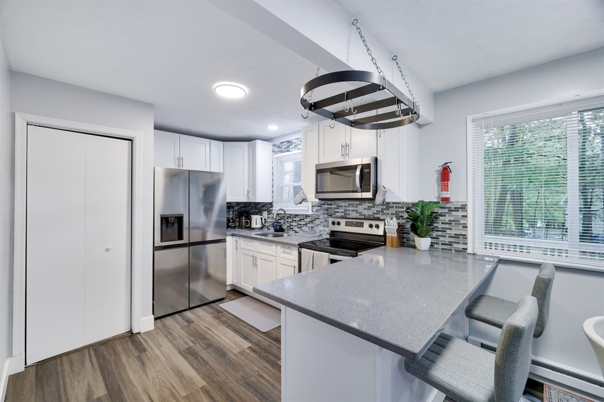 Living area with smart TV and plush couches — perfect for movie nights with family or friends.