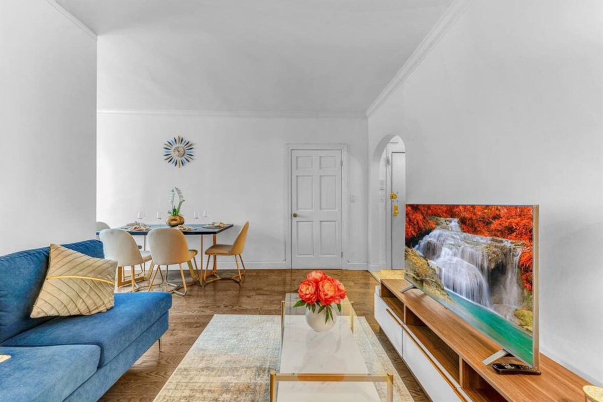 Open-plan living and dining area with smart TV, comfortable seating, and natural light — perfect for relaxing after expl