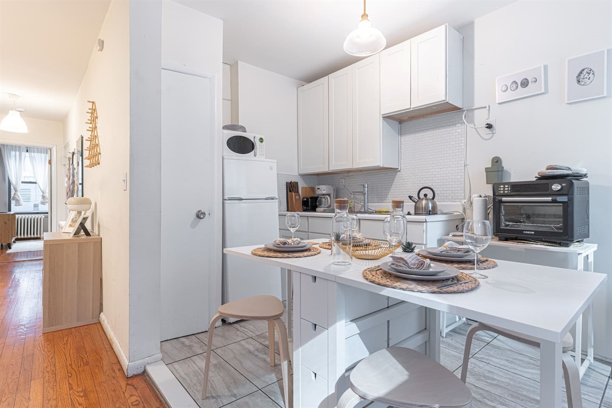 Spacious open-plan living area with hardwood floors and modern décor — perfect for unwinding after a day in Midtown Manh