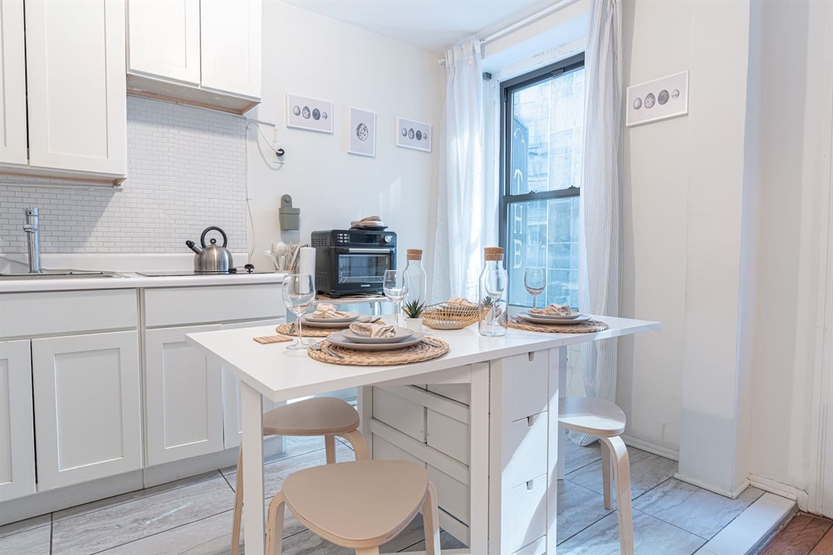 Bright NoMad living room with smart TV, plush seating, and natural light — your stylish 3BR retreat steps from the Empir