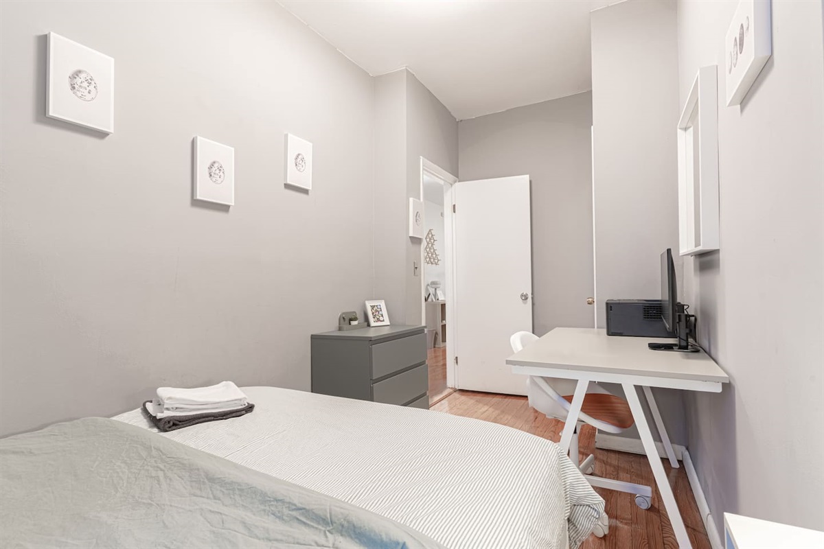 Inviting third bedroom with quality bedding and storage — ideal for families, friends, or business travelers.