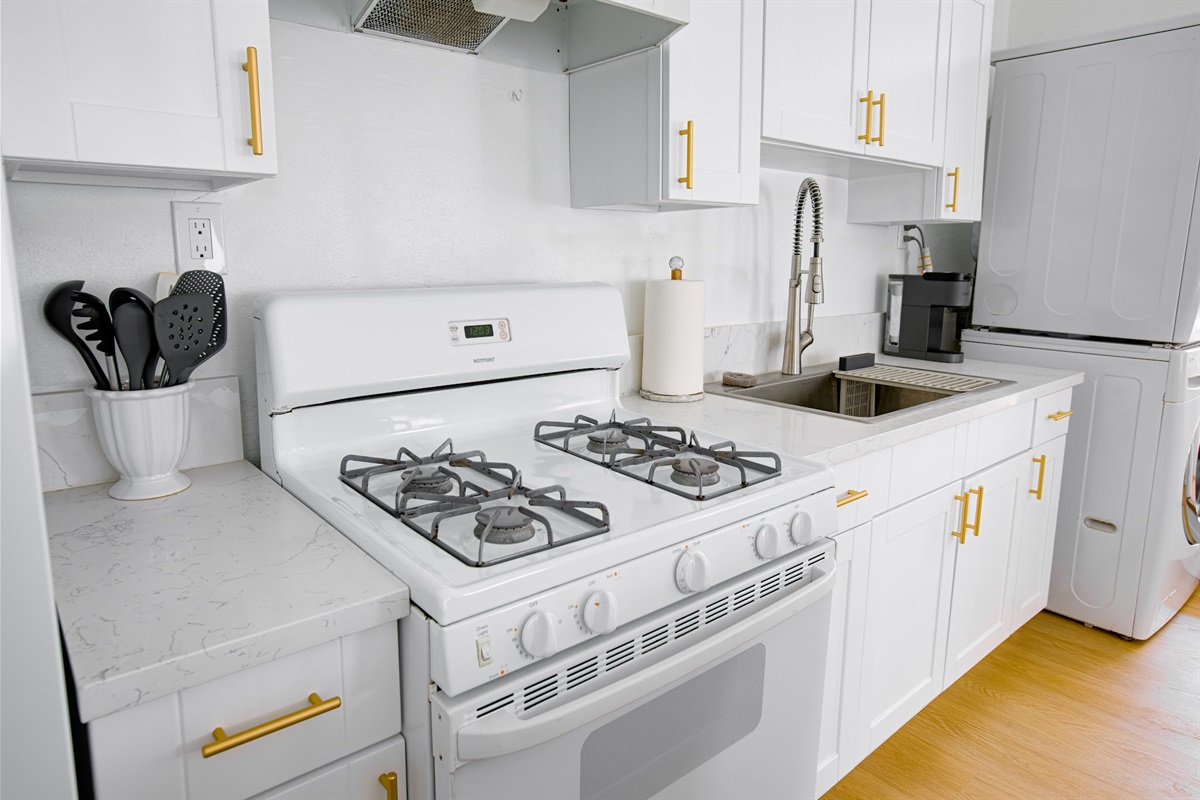 Full-size gas stove and oven — everything you need to prepare a home-cooked meal.