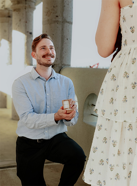 Man with ring in box, woman standing, man on one knee, proposal