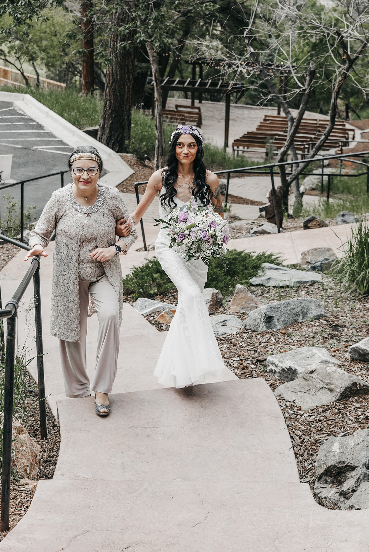 A mother walking her daughter in her bridal gown up the boardwalk to her groom. Both smiling in rapture. 
