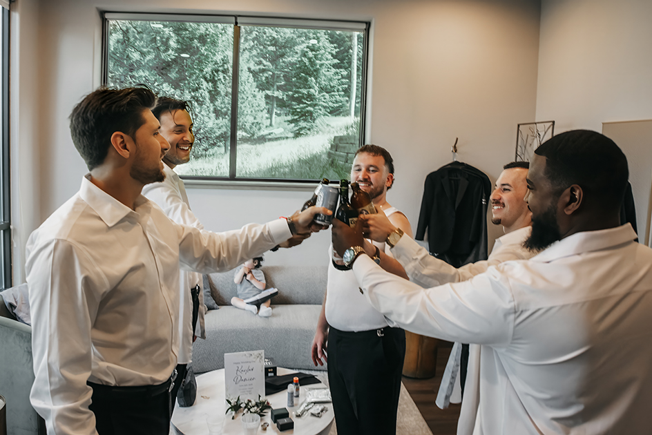 Groomsmen in the getting ready room toasting to new beginnings
