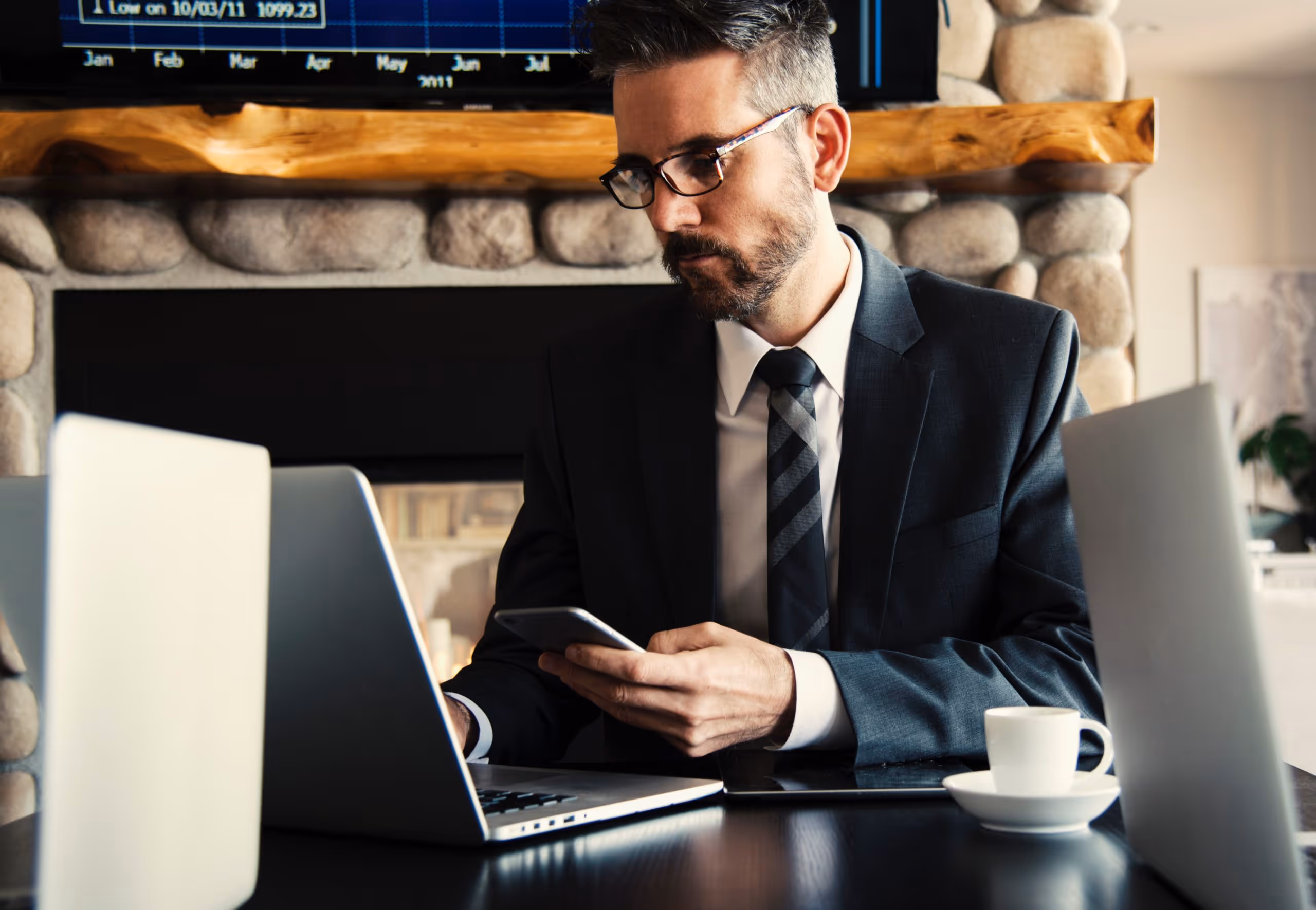 Professionnel consultant son téléphone au bureau, gestion charge mentale travail, équilibre vie professionnelle