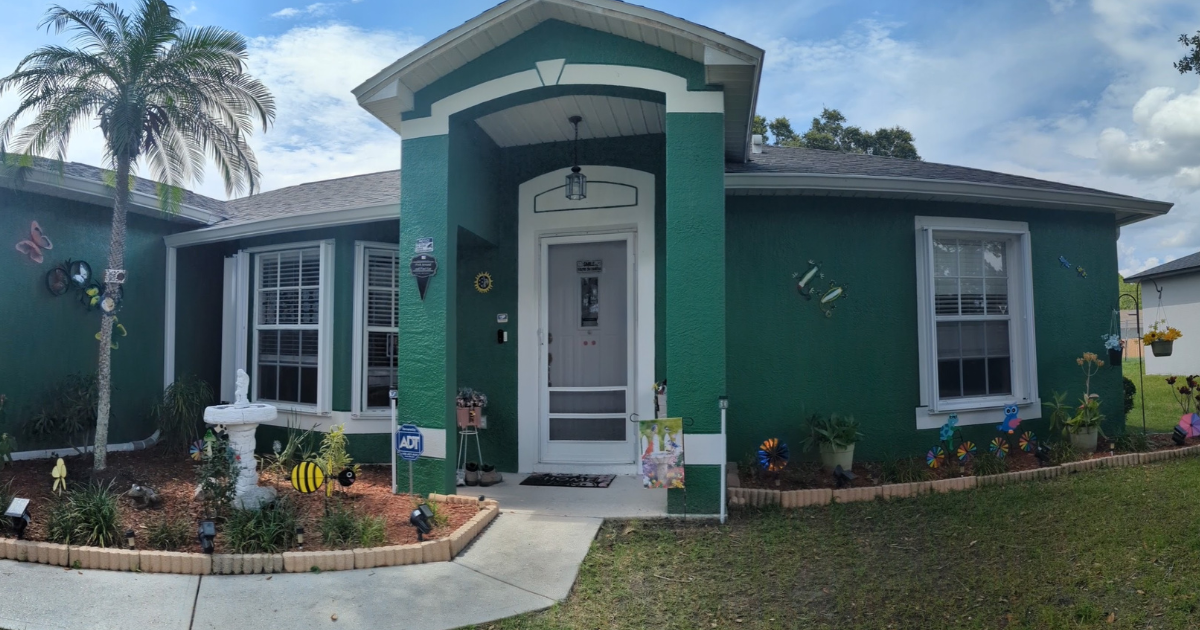 green house with white accordion shutters