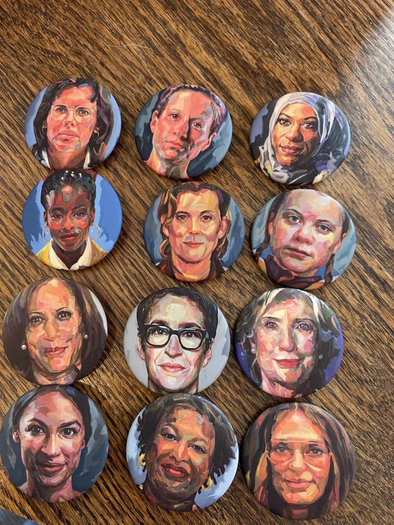 Selection of Persisters Pins by Jo Hay displayed on a table